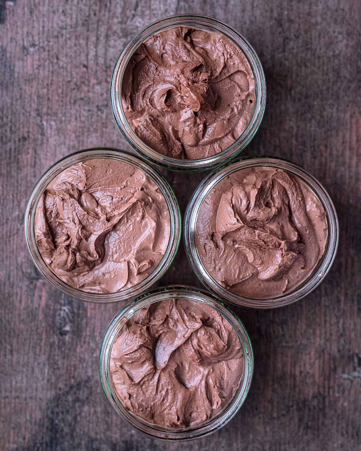 The chocolate yogurt mixture divided into four serving glasses.