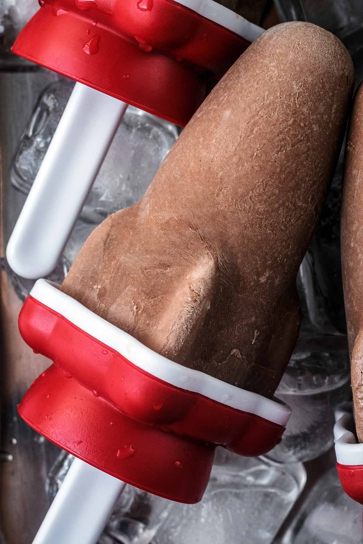 A chocolate popsicle in the shape of a space rocket.