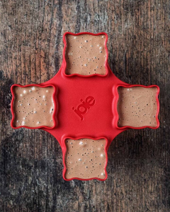 A four section popsicle mould with the mixture in it.