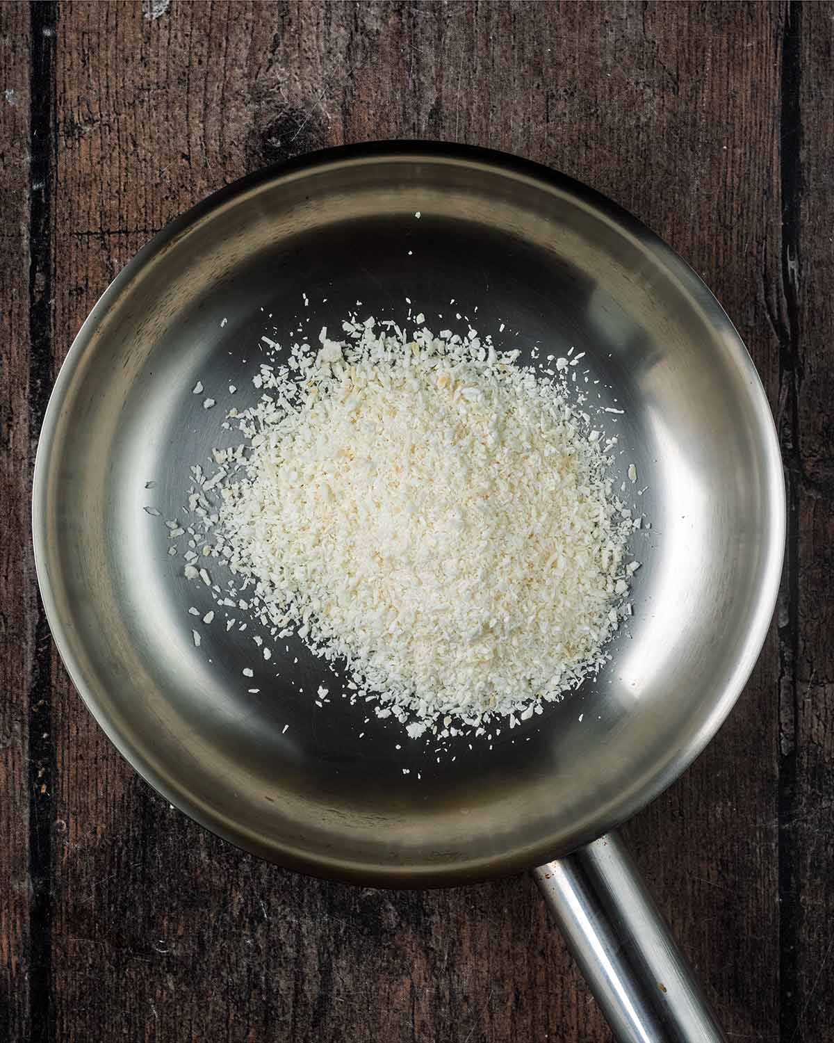 Desiccated coconut in a frying pan.