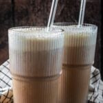 Protein cold foam on top of two glasses of iced coffee.