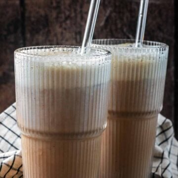 Protein cold foam on top of two glasses of iced coffee.