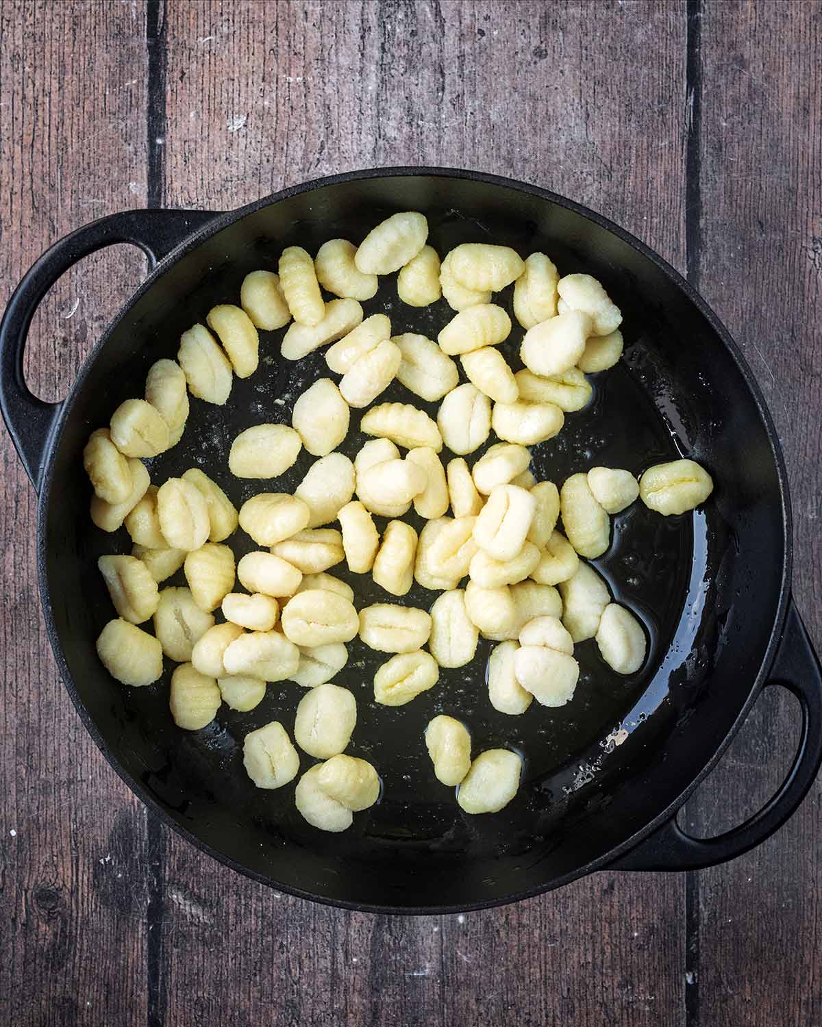 Gnocchi in a black pan.