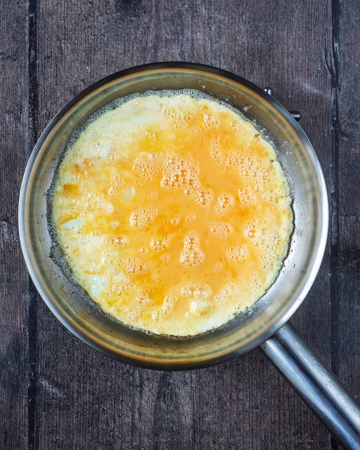 Whisked eggs in a frying pan.