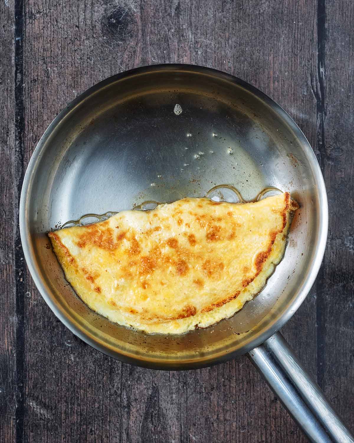 A folded omelette in a frying pan.