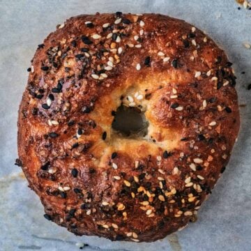 A greek yogurt bagel topped with sesame seeds.
