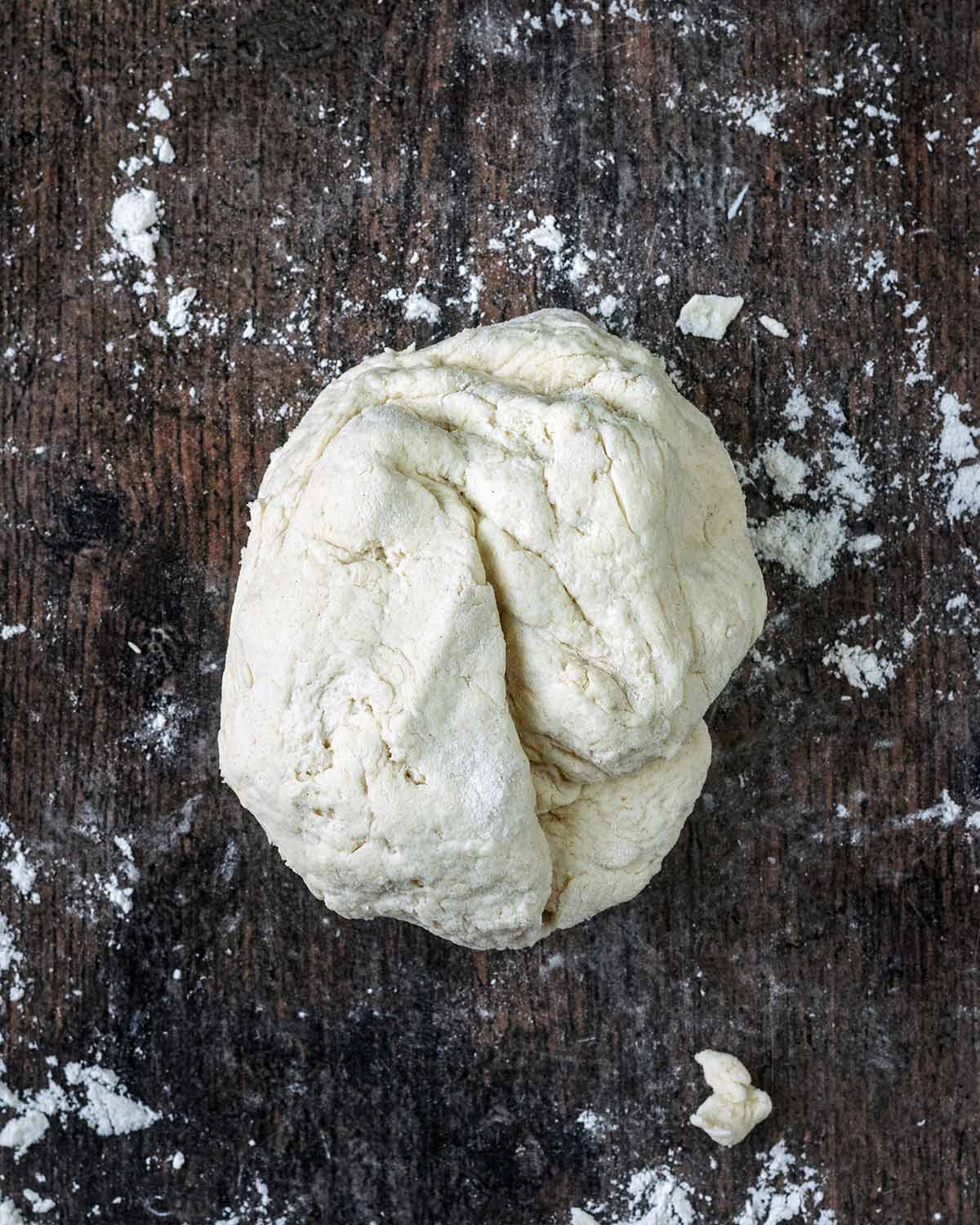 A ball of dough on a floured surface.