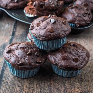 Three high protein greek yogurt chocolate muffins stacked up.