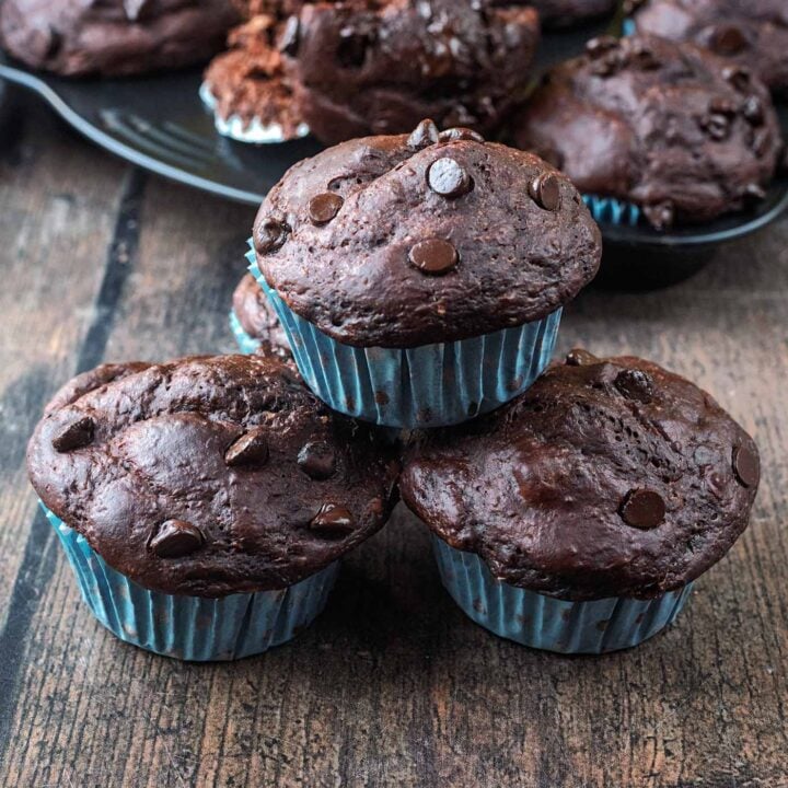 Three high protein greek yogurt chocolate muffins stacked up.