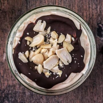 Snickers Greek yogurt pot on a wooden surface.