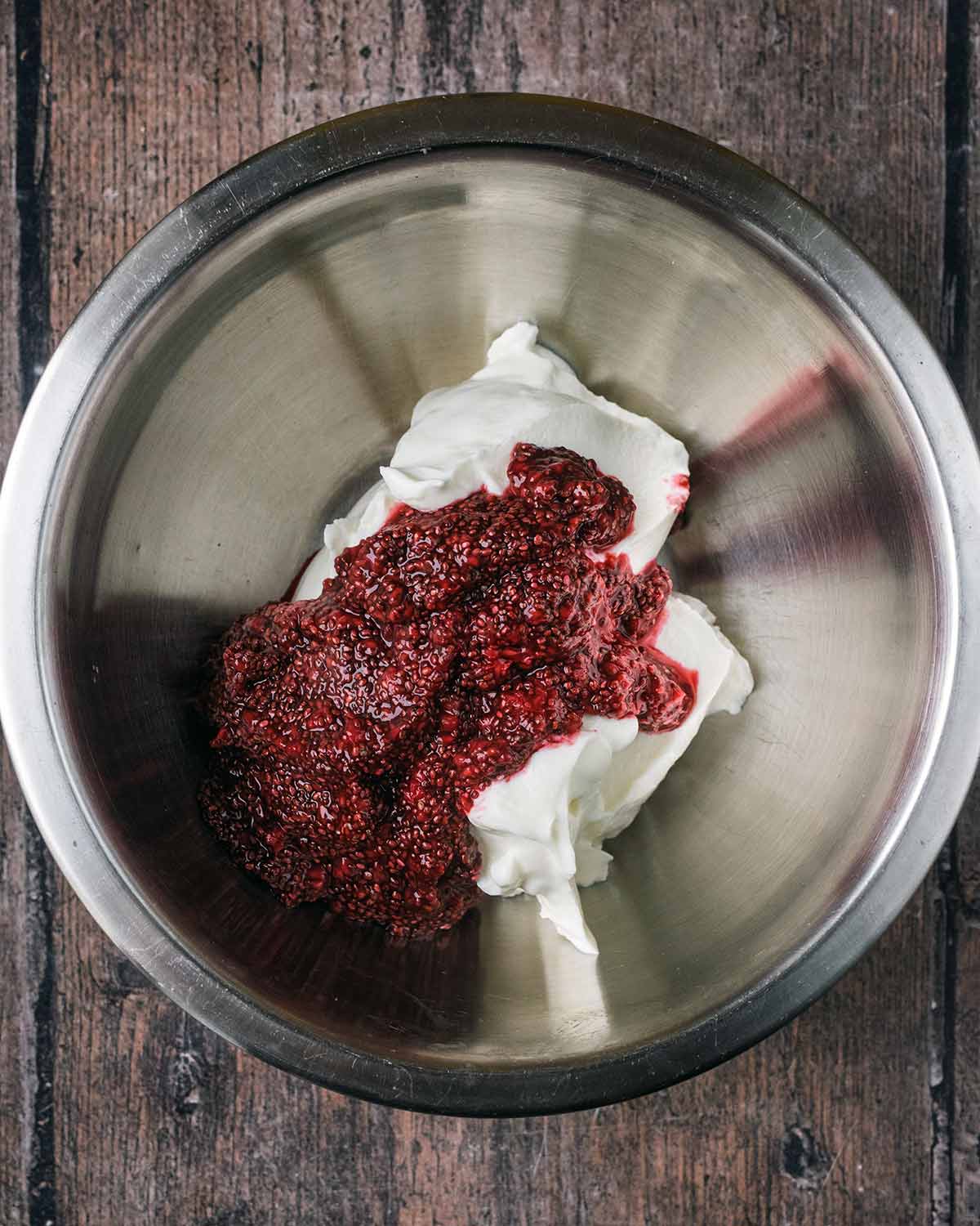 Chia jam and yogurt in a mixing bowl.