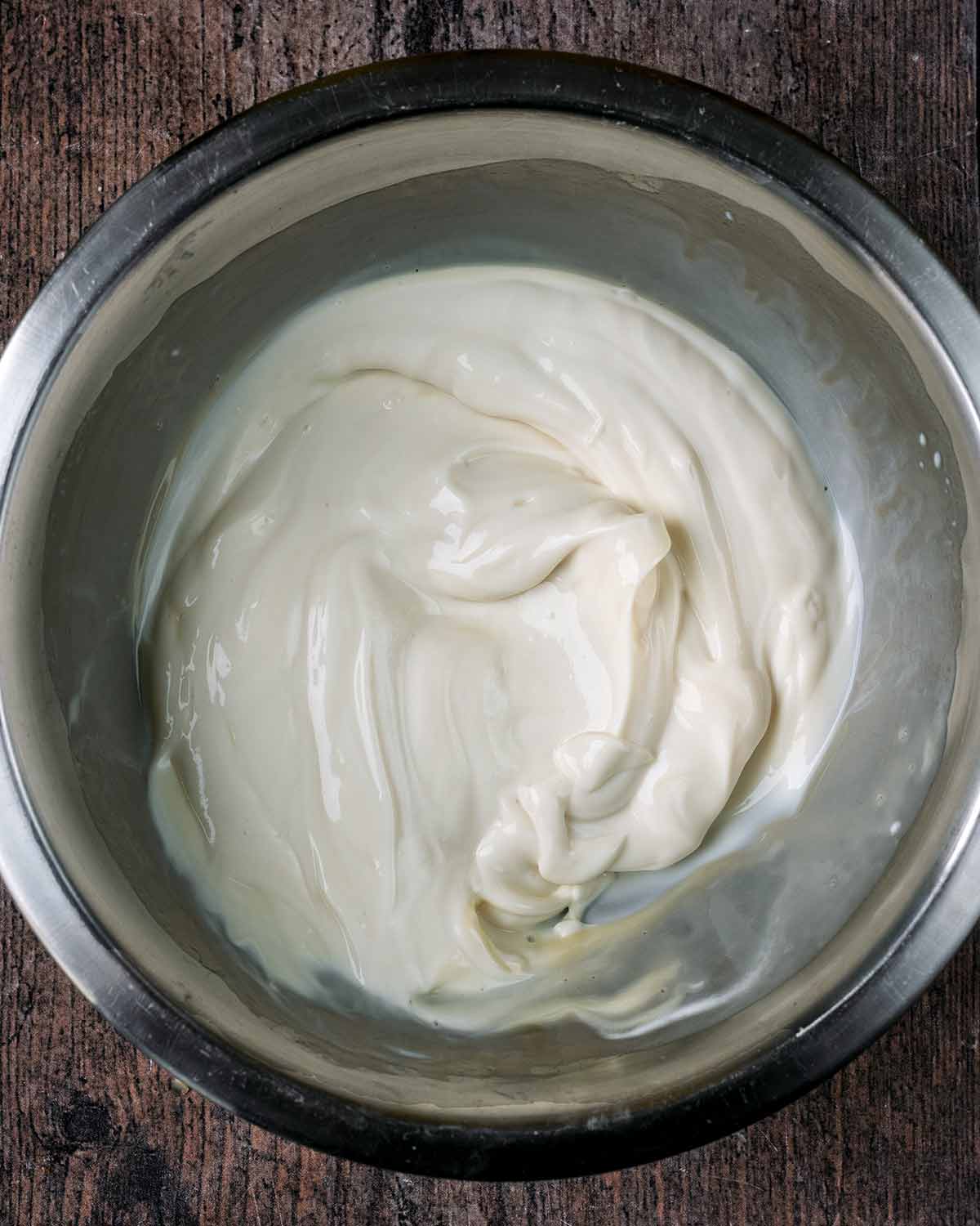 The yogurt and vanilla mixed together in the bowl.