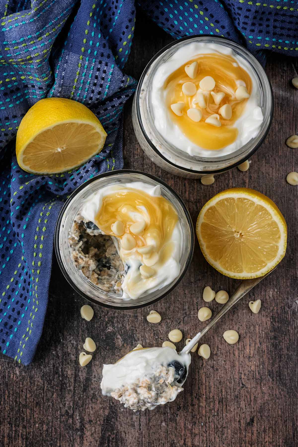 Two jars of overnight oats, one with a spoonful removed.