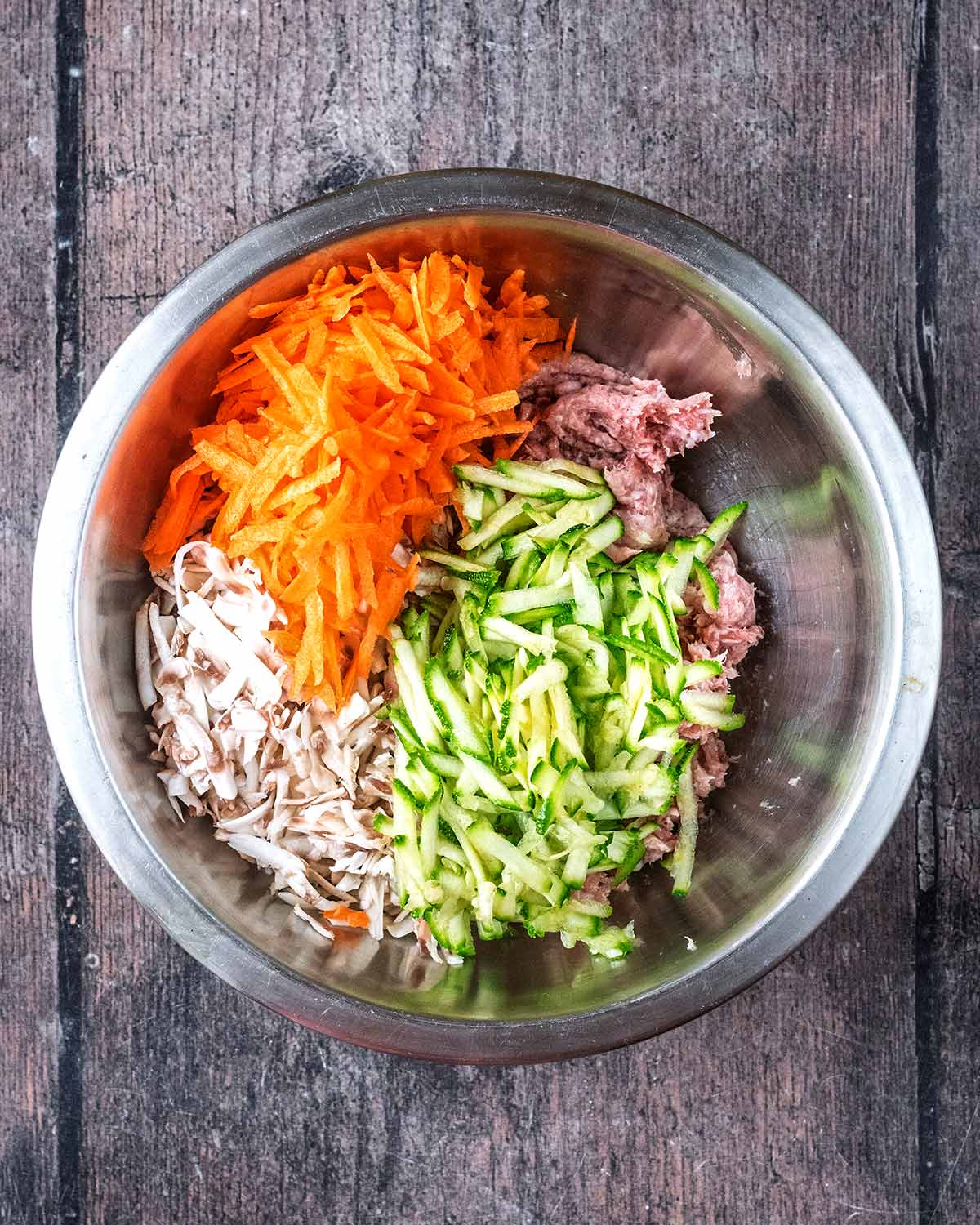 grated, carrot, courgette and mushrooms added to the bowl.