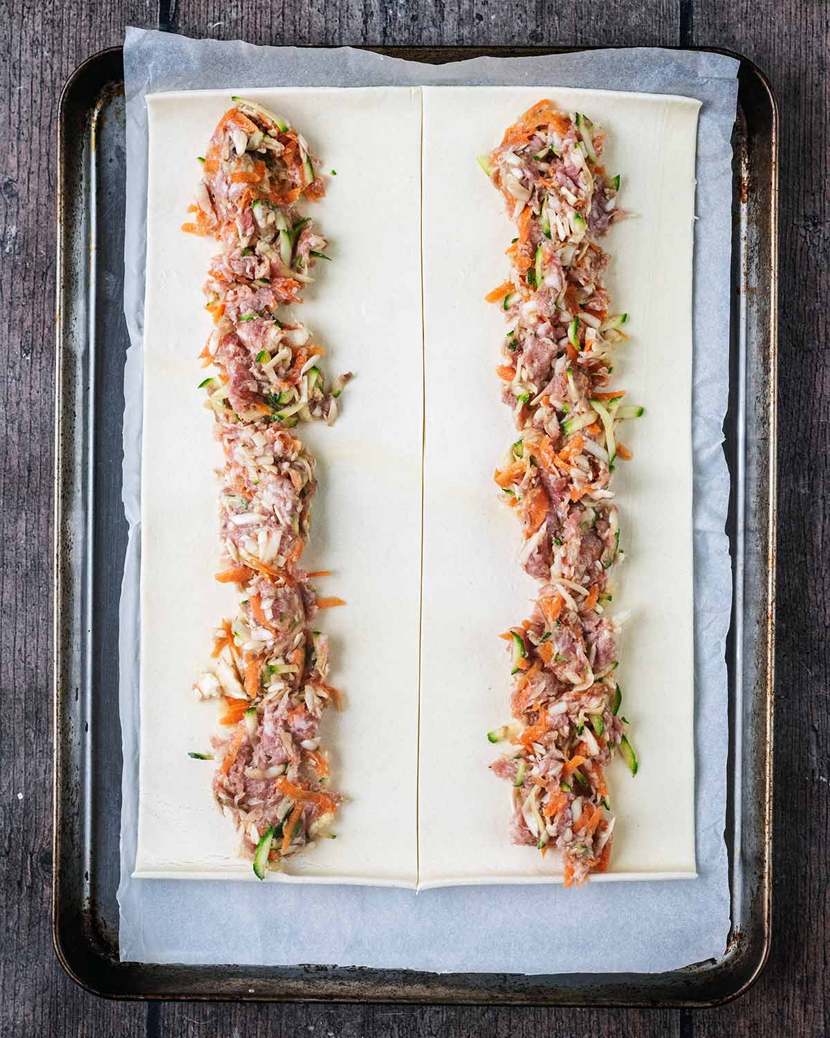 Two rows of the sausage mixture along the length of the pastry.