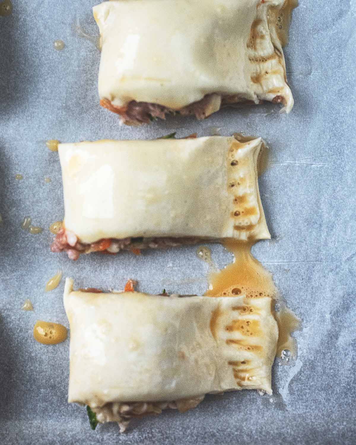 Egg wash applied to the tops of each roll.