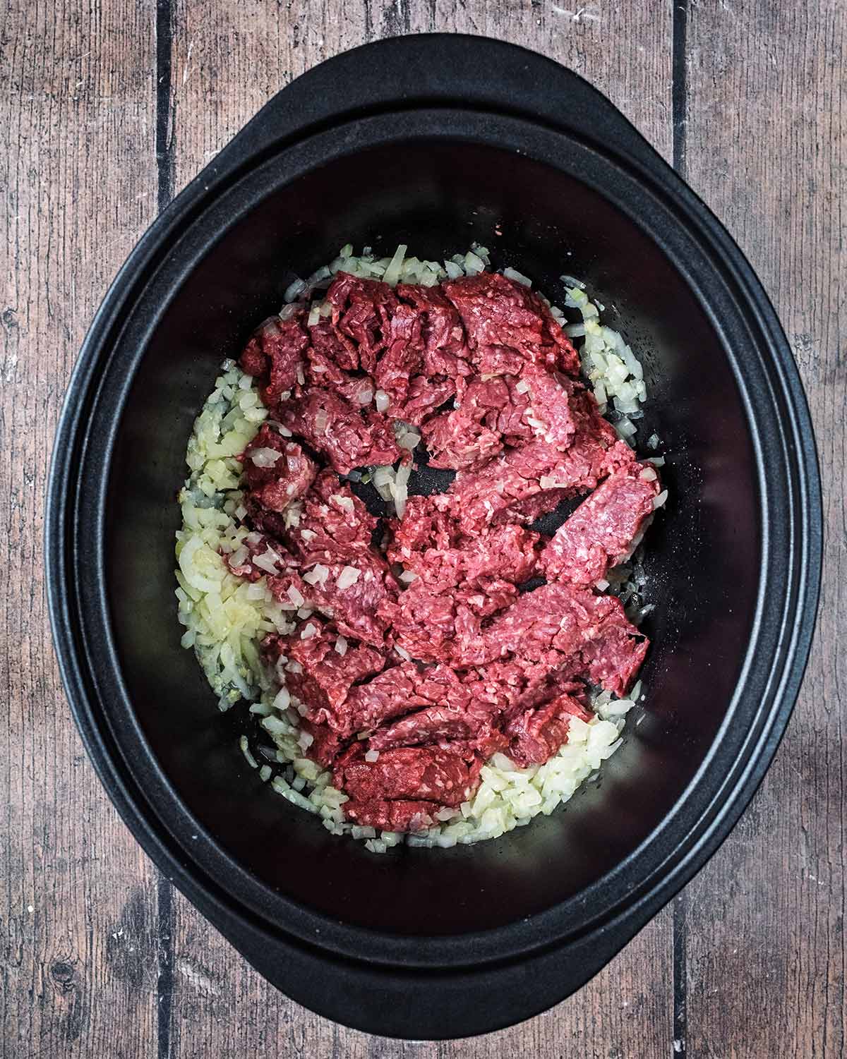 Raw beef mince added to the slow cooker.