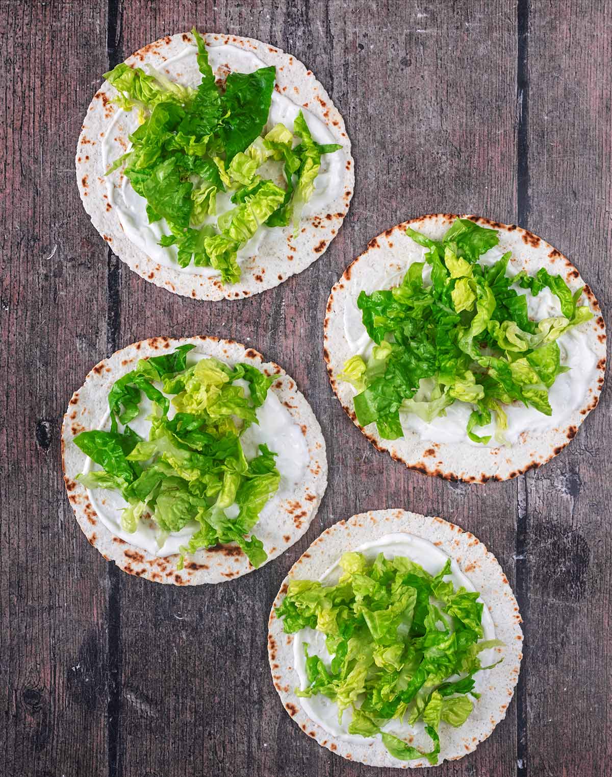 Chopped lettuce added to the tacos.