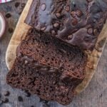 Chocolate courgette loaf cake with two slices cut off.