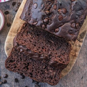 Chocolate courgette loaf cake with two slices cut off.
