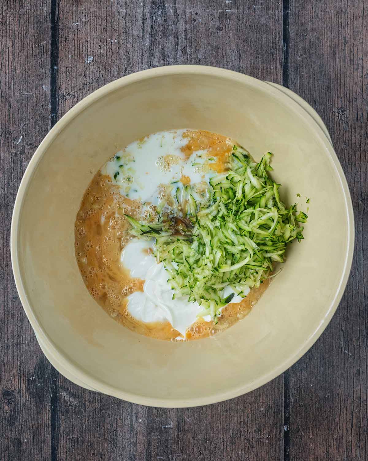 Yogurt, milk and grated courgette added to the bowl.