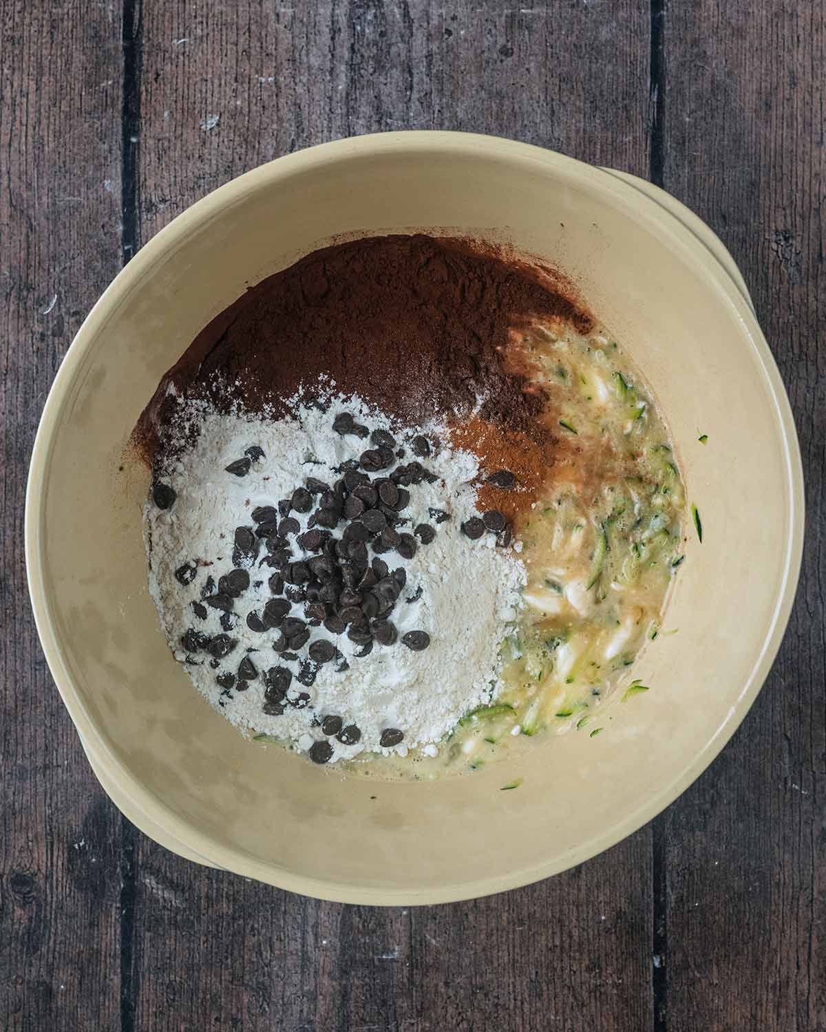 Flour, cocoa powder and chocolate chips added to the bowl.